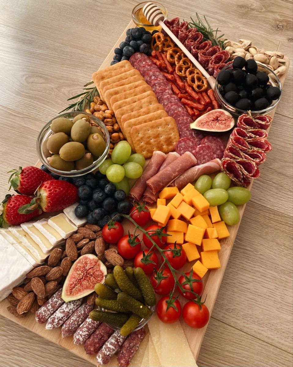 Charcuterie board with cheese, fruit, and crackers